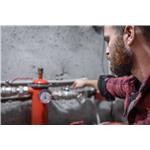 man-looks-faucet-pipes-valve-pressure-meter.jpg